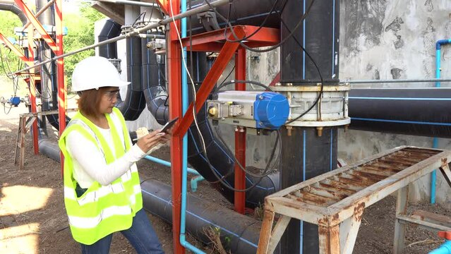 A female engineer working at a water treatment plant, inspecting and maintaining the water supply system, checking chlorine levels, ensuring water quality, and overseeing the dynamo motors and control