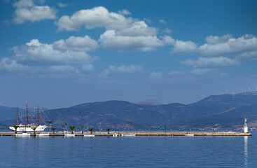 Naklejka premium Sailing ship and small fishing boats in the harbor Nafplio Greece