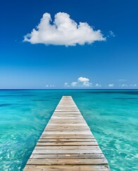 Fototapeta premium Long Wooden Pier Extending Over Clear Turquoise Ocean