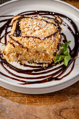 A piece of Napoleon cake dipped in chocolate