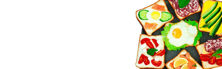 appetizing sandwiches in a gray plate on a white background. slices of bread with vegetables and meat in a plate on a light texture	