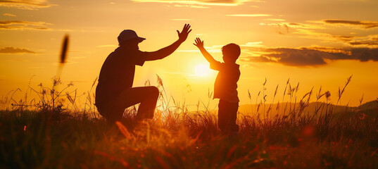 Silhouette of happy father high five with his son, Father's day concept, parent and child relations