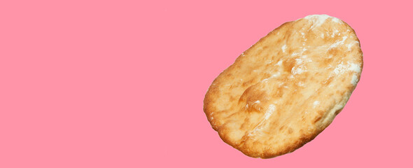 round georgian pita bread on a pink background. round flat bread on a light surface	