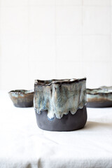Stoneware mug with blue glaze, ideal for hot drinks. Light background. Front view.