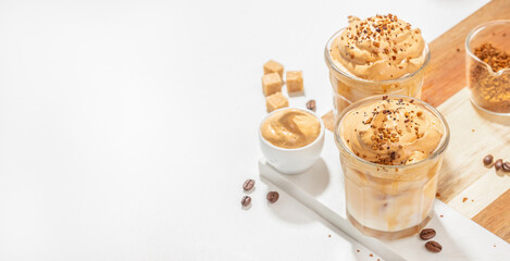 Dalgona coffee, Iced creamy whipped coffee foam and milk. Long banner format. top view. copy space for text