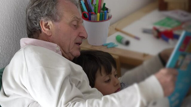 Grandfather and young grandson reading a comic book together, emphasizing the bonding and shared joy of storytelling in a cozy home environment