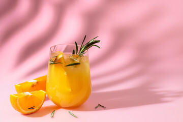 Summer cocktail with orange, rosemary, and ice.