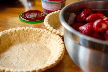 The making of a chilled strawberry glazed pie: A flour crust has been baked and cooled.  Ready for...