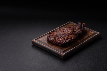Delicious juicy beef ribeye steak grilled with salt, spices and herbs