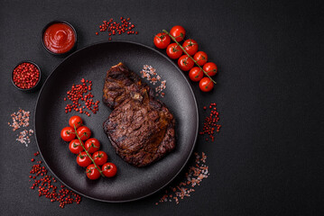 Delicious juicy beef ribeye steak grilled with salt, spices and herbs