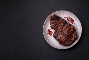 Delicious juicy beef ribeye steak grilled with salt, spices and herbs