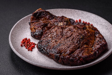 Delicious juicy beef ribeye steak grilled with salt, spices and herbs