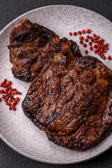 Delicious juicy beef ribeye steak grilled with salt, spices and herbs