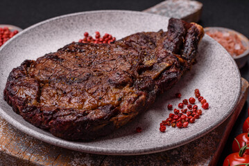 Delicious juicy beef ribeye steak grilled with salt, spices and herbs