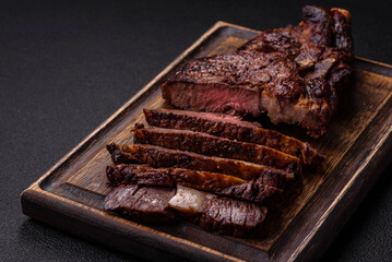 Delicious juicy beef ribeye steak grilled with salt, spices and herbs