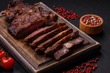 Delicious juicy beef ribeye steak grilled with salt, spices and herbs