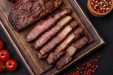 Delicious juicy beef ribeye steak grilled with salt, spices and herbs
