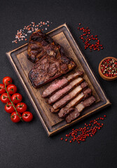Delicious juicy beef ribeye steak grilled with salt, spices and herbs
