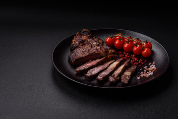Delicious juicy beef ribeye steak grilled with salt, spices and herbs
