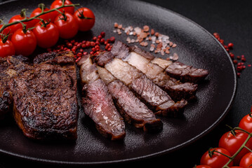Delicious juicy beef ribeye steak grilled with salt, spices and herbs
