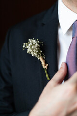 flower, detail on the groom's outfit