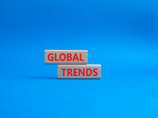 Global Trends symbol. Wooden blocks with words Global Trends. Beautiful blue background. Business...