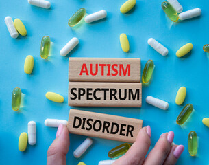 Autism Spectrum Disorder symbol. Concept word Autism Spectrum Disorder on wooden blocks. Doctor...