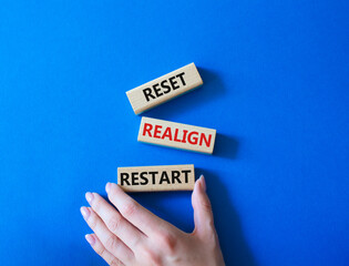 Reset Realign Restart symbol. Concept words Reset Realign Restart on wooden blocks. Businessman...