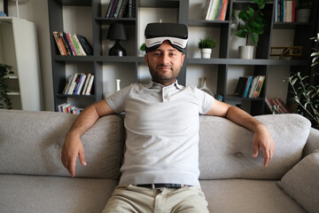 Young man experiencing virtual reality at home