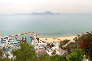 May 17th 2024. Sidi Bou Said, Tunisia. .Scenic view of Sidi Bou Said beach and harbour from the famous cliff top village a popular tourist destination on the Mediterranean coast of Tunisia .