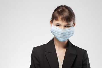 Professional young woman in business attire with medical face mask