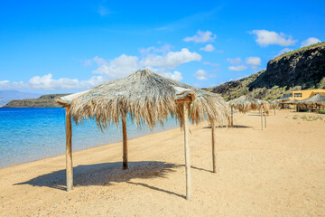 Sable Blanc sand beach with straw huts and turquoise sea, Tajourah region, Djibouti, Horn of Africa