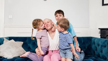 Ill mother smiling has emotional support from her three children