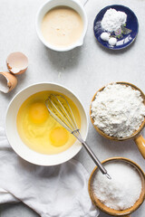 Overhead view of mise en place of ingredients for making a lemon cake, flatlay of ingredients for making lemon pound cake, process of making cake