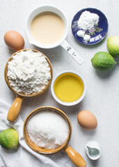 Overhead view of mise en place of ingredients for making a lemon cake, flatlay of ingredients for making lemon pound cake, process of making cake