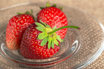a lot of red strawberries in the dish