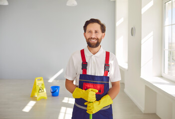Janitor from cleaning service at work. Cleaning company worker helps keep indoor space clean and...
