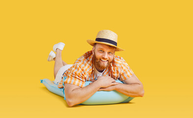 Happy man in beach holiday wear, straw sun hat, tourist lying on summer inflatable mattress....