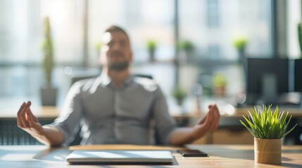 Man meditating at his desk in a sunlit office space. Stress relief and mindfulness at work.
