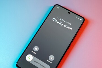 Charity Scam call concept on mobile phone. Person get scam call alert. Phone call from unknown...