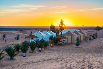 Luxury tent camp at Erg Chebbi Sahara desert at sunrise near Merzouga town, Morocco, North Africa
