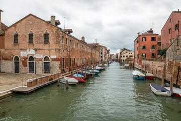 Exposure of the Venice water canals showing old building architecture and boats. Taken on a sunshiny day showing the pretty views of this magnificent city.