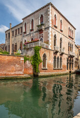 Exposure of the Venice water canals showing old building architecture and boats. Taken on a sunshiny day showing the pretty views of this magnificent city.
