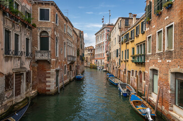 Exposure of the Venice water canals showing old building architecture and boats. Taken on a sunshiny day showing the pretty views of this magnificent city.