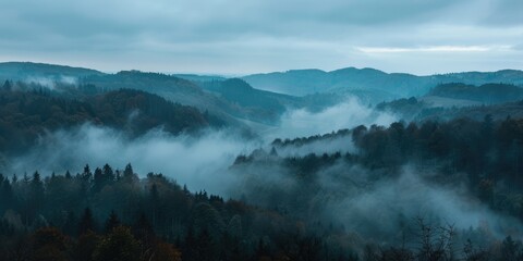 landscape view over foggy forest with hills
