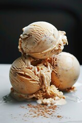 Scoops of creamy ice cream stacked on plate