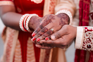 Indian, bride and hands with ring, marriage and morning with henna, luxury and culture for woman. Celebration, jewellery and person with clothes in wedding, ceremony or traditional for event in Dubai