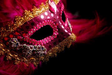 Venetian carnival mask on dark background with smoke, selective focus.