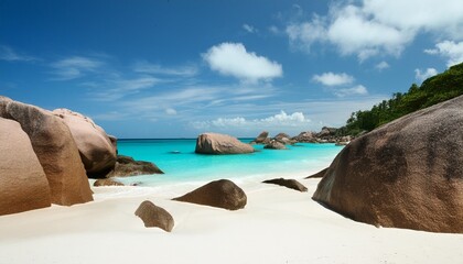 white sand turquoise water and granite boulders in a tropical beach