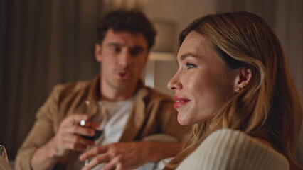 Romantic lovers talking sofa enjoying evening date in apartment close up